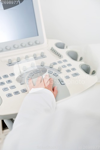 Image of Obstetrician Using Ultrasound Machine