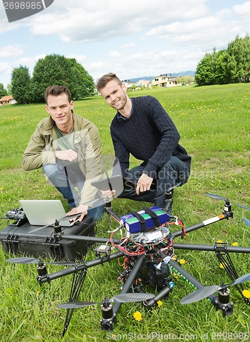 Image of Technicians With Laptop And Digital Tablet By UAV