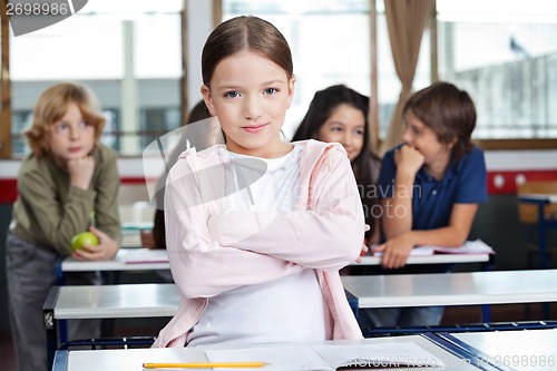 Image of Schoolgirl Standing Arms Crossed In Classroom