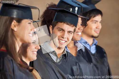 Image of Happy Man Standing With Students On Graduation Day In College