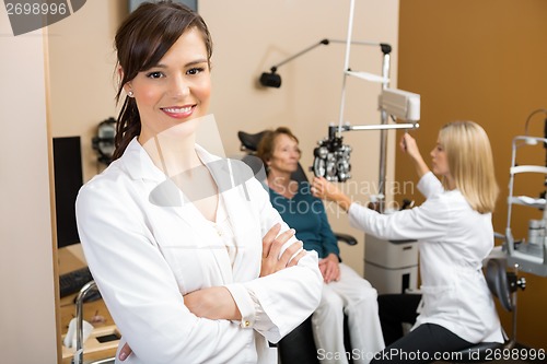 Image of Eye Specialist With Colleague Examining Patient