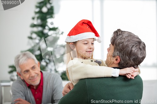 Image of Girl Embracing Father During Christmas