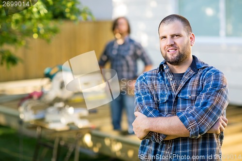 Image of Confident Manual Worker With Hands Folded At Construction Site