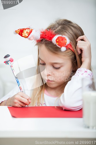 Image of Girl Wearing Headband Writing Letter To Santa Claus