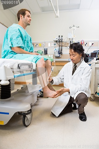 Image of Doctor Examining Male Patient's Reflex