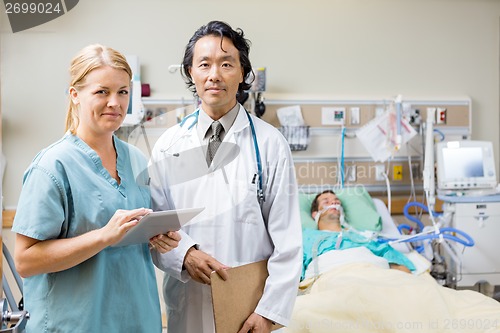 Image of Nurse And Doctor With Patient Resting In Hospital