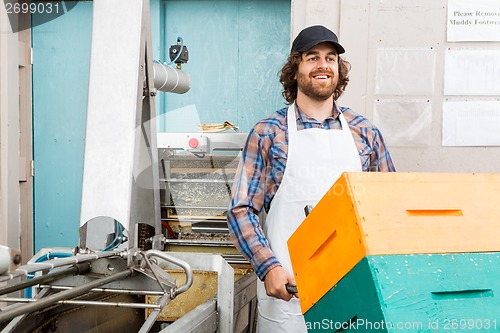 Image of Beekeeper With Trolley Of Stacked Honeycomb Crates