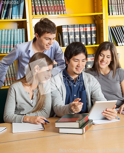 Image of Students With Digital Tablet Discussing In College Library