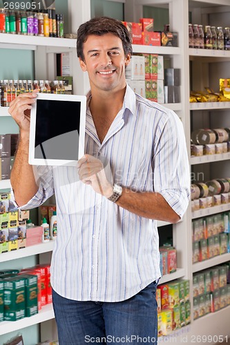 Image of Man Showing Digital Tablet In Supermarket