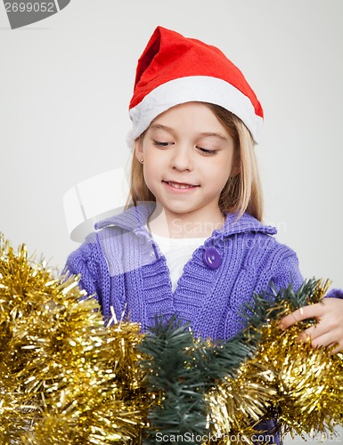 Image of Girl Looking At Tinsels During Christmas