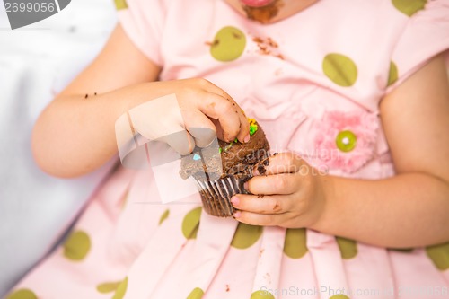 Image of Birthday Girl Eating Cupcake