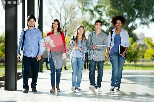 Image of Confident Students Walking In A Row On Campus