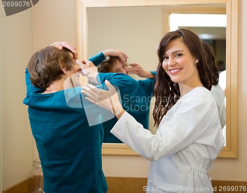 Image of Ophthalmologist Assisting Woman To Insert Contact Lens