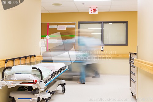 Image of Nurses With Stretcher Walking In Hospital Corridor