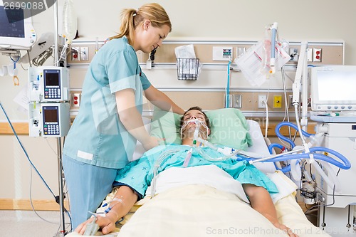 Image of Nurse Adjusting Patient's Pillow