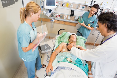 Image of Doctor Defibrillating Critical Patient In Hospital