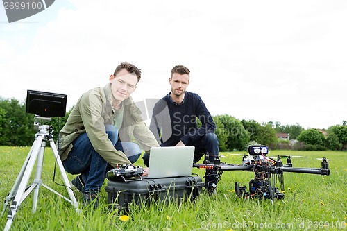 Image of Engineers Using Laptop By UAV Helicopter