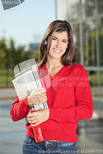 Image of Student With Books And Juice Bottle At University Campus