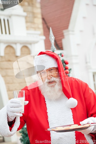 Image of Santa Claus With Cookies And Milk