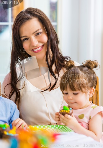 Image of Mother With Birthday Girl Eating Cake