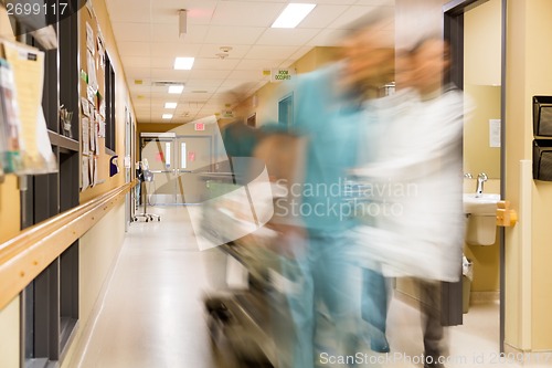 Image of Doctor And Nurse Pulling Stretcher In Hospital