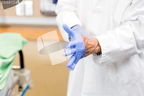 Image of Doctor Wearing Sterilized Gloves In Hospital