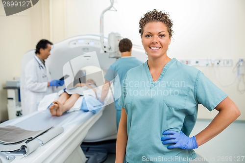 Image of Nurse With Colleague And Doctor Preparing Patient For CT Scan