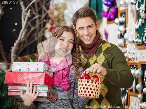 Image of Couple Shopping Presents In Christmas Store