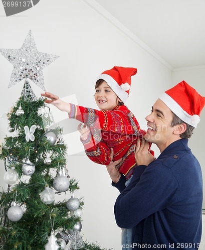 Image of Boy And Father Decorating Christmas Tree