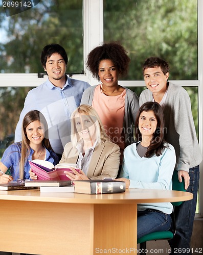 Image of University Students And Professor With Books In Classroom