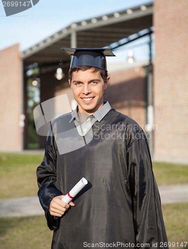 Image of Graduate Student Holding Diploma On Graduation Day At Campus