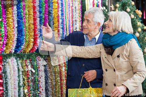 Image of Couple Shopping For Tinsels At Store