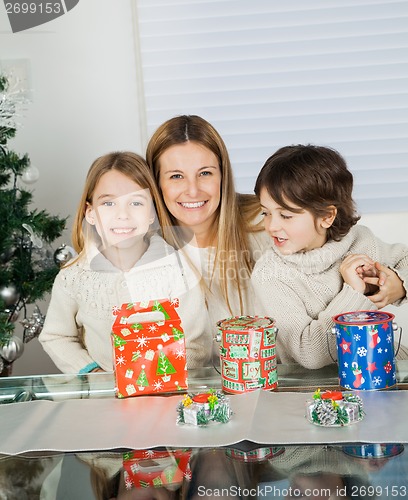 Image of Loving Mother And Siblings With Christmas Presents