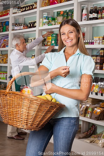 Image of Happy Woman Holding Shopping Basket