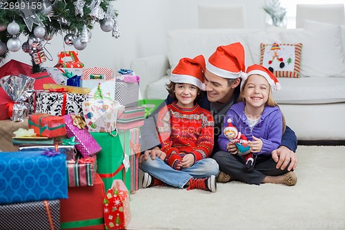 Image of Siblings With Father At Home During Christmas