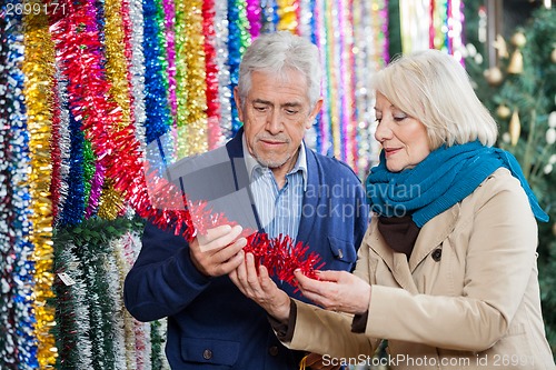 Image of Couple Choosing Tinsels At Store