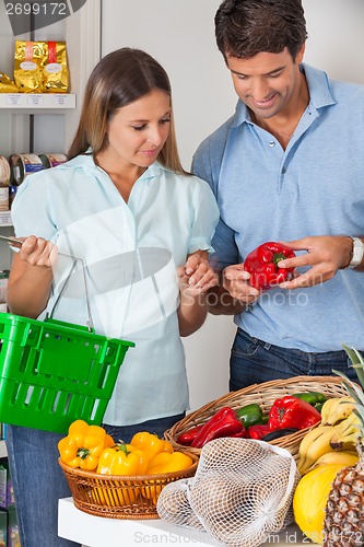 Image of Couple Buying Vegetables In Grocery Store