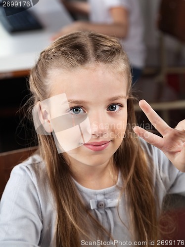 Image of Schoolgirl Gesturing Victory Sign In Computer Lab