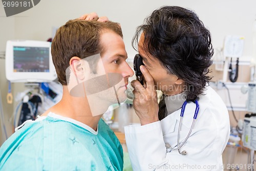 Image of Doctor With Ophthalmoscope Examining Patient's Eye