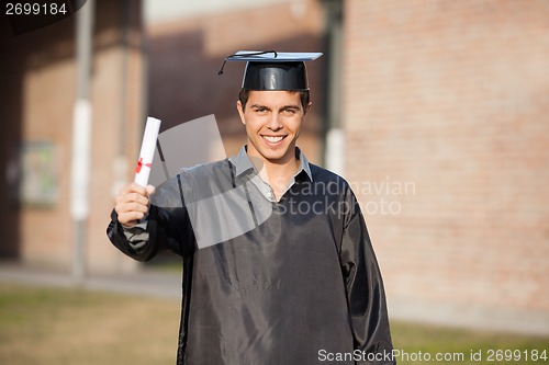 Image of Confident Student Showing Diploma On Graduation Day At Campus