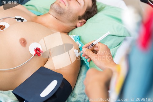 Image of Nurse Injecting Syringe On Patient's Arm In Hospital