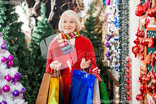 Image of Woman With Shopping Bags Standing At Christmas Store