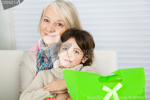 Image of Senior Woman Embracing Boy During Christmas