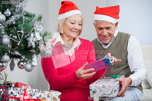 Image of Senior Couple Looking At Christmas Presents