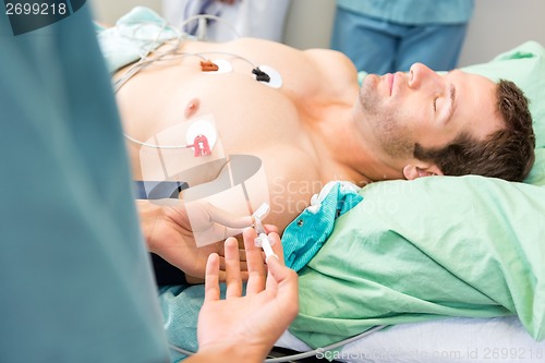 Image of Female Nurse Injecting Critical Patient On Arm