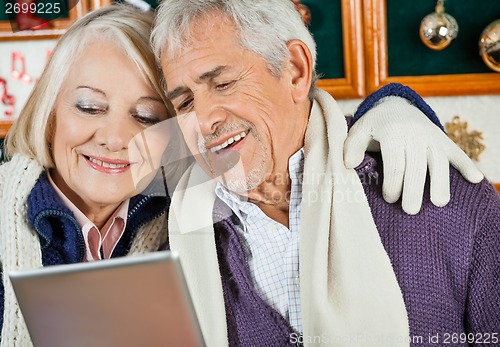 Image of Couple Using Digital Tablet At Christmas Store