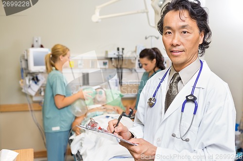Image of Doctor Holding Clipboard in Emergency
