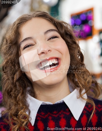 Image of Woman Laughing In Christmas Store