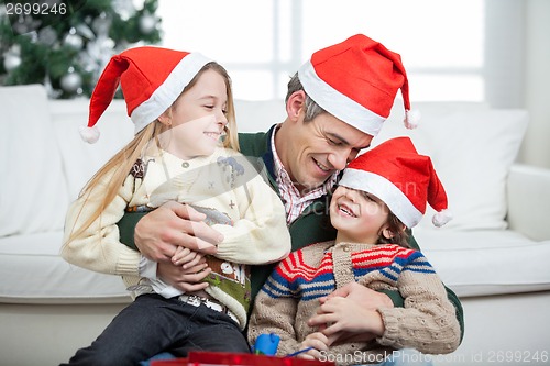 Image of Loving Father With Arms Around Children