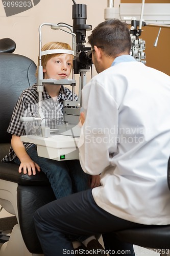 Image of Optician Examining Boy's Eyes With Slit Lamp